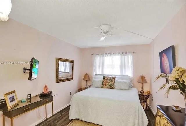 bedroom with dark hardwood / wood-style floors and ceiling fan