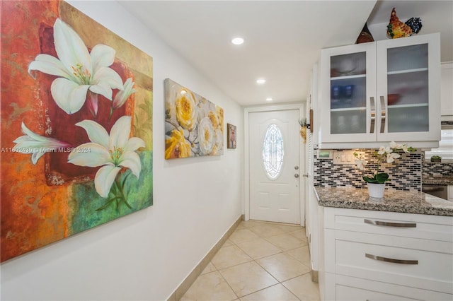 doorway to outside featuring light tile patterned floors