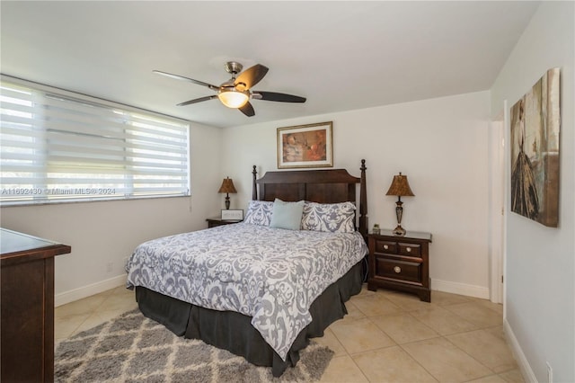 bedroom with ceiling fan and light tile patterned flooring