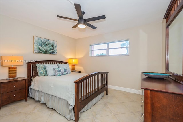 tiled bedroom featuring ceiling fan