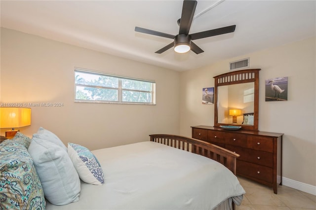 tiled bedroom featuring ceiling fan