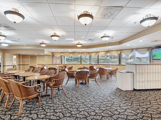 dining room featuring carpet flooring and a paneled ceiling