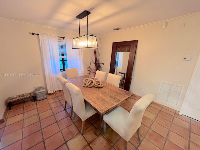 dining area featuring tile patterned floors and ornamental molding