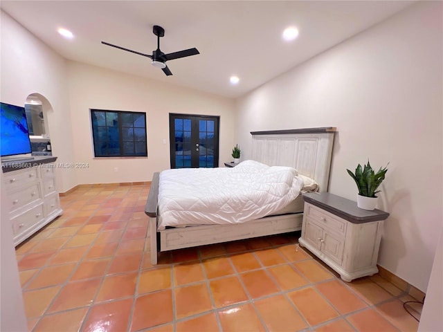 tiled bedroom with ceiling fan and vaulted ceiling