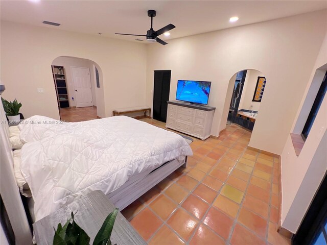 tiled bedroom featuring ceiling fan