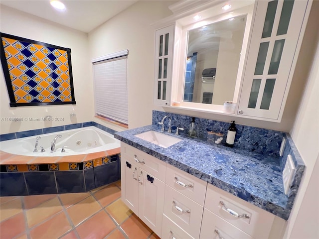 bathroom with vanity, a tub, and tile patterned floors