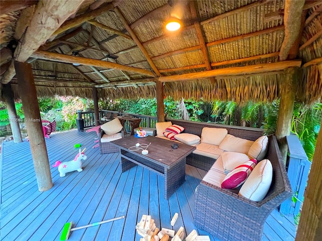 wooden terrace featuring an outdoor living space and a gazebo