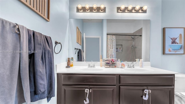 bathroom with curtained shower, vanity, and toilet