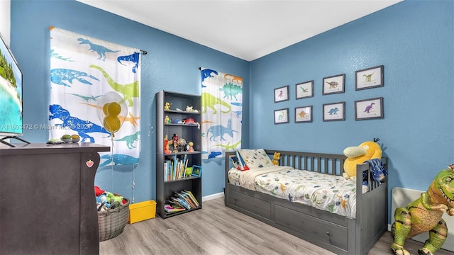 bedroom with light hardwood / wood-style floors