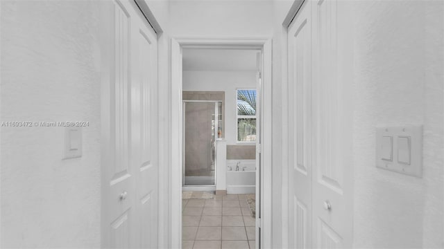 corridor featuring light tile patterned floors