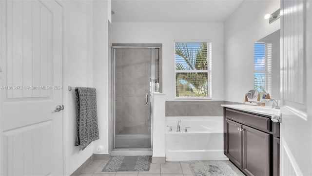 bathroom featuring tile patterned flooring, vanity, and separate shower and tub