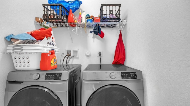 clothes washing area with washing machine and clothes dryer