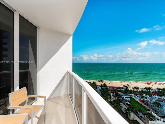 balcony with a beach view and a water view