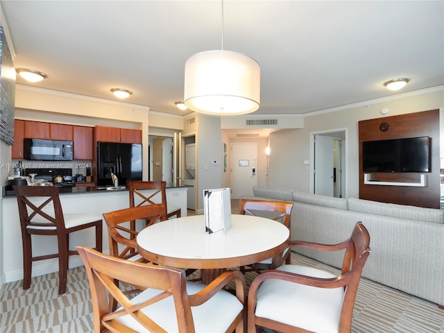 dining space with ornamental molding