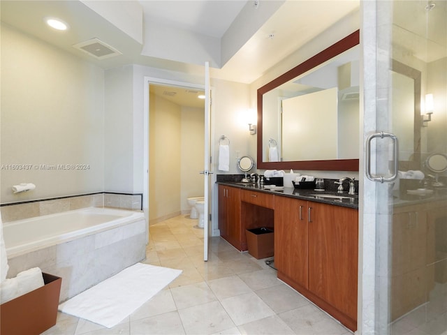 bathroom with vanity, a relaxing tiled tub, toilet, and tile patterned floors