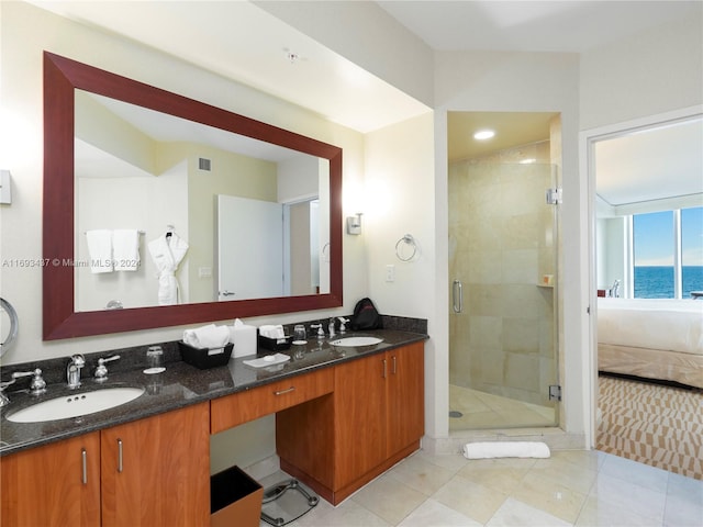 bathroom with vanity, tile patterned flooring, a water view, and a shower with shower door