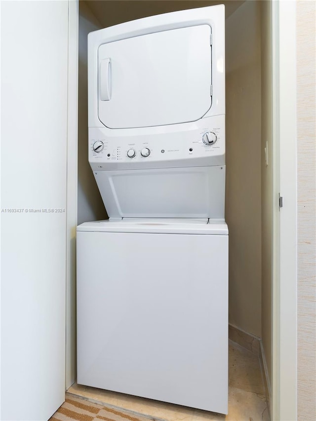 laundry area with stacked washer / dryer