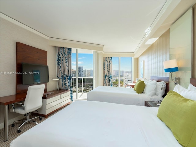 bedroom with access to outside, crown molding, and expansive windows