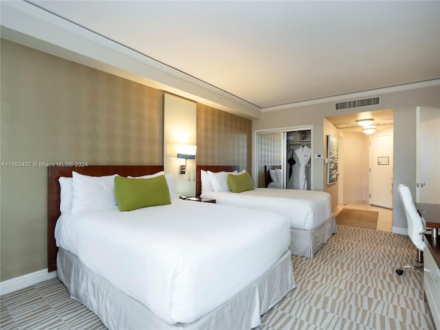 bedroom with crown molding and a closet