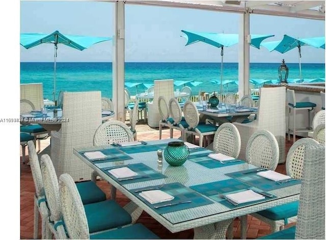 dining space featuring a water view and hardwood / wood-style flooring