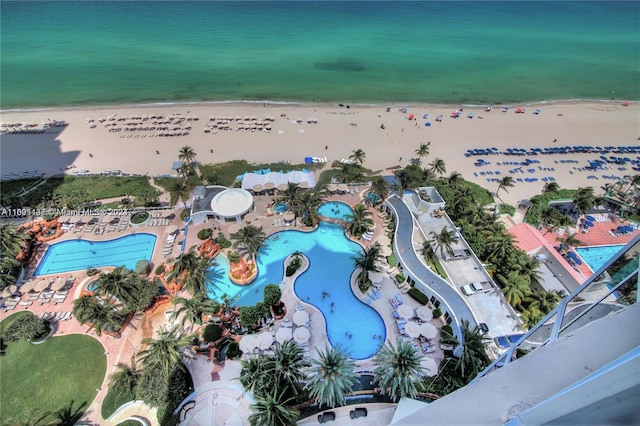 drone / aerial view with a water view and a beach view