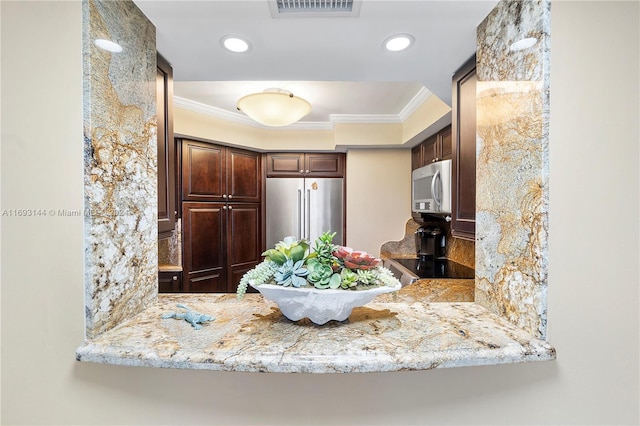 kitchen with kitchen peninsula, appliances with stainless steel finishes, dark brown cabinetry, and crown molding