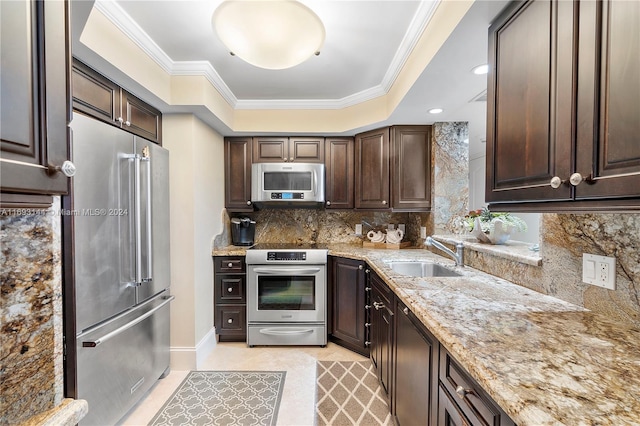 kitchen featuring sink, light stone countertops, ornamental molding, dark brown cabinetry, and stainless steel appliances