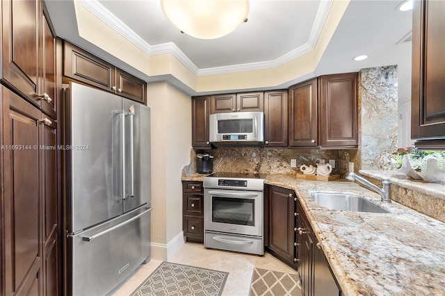 kitchen featuring crown molding, sink, light stone countertops, dark brown cabinets, and stainless steel appliances