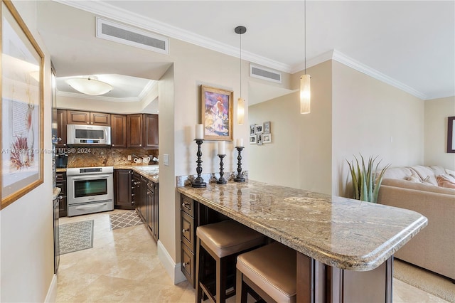 kitchen with backsplash, ornamental molding, appliances with stainless steel finishes, decorative light fixtures, and dark brown cabinetry