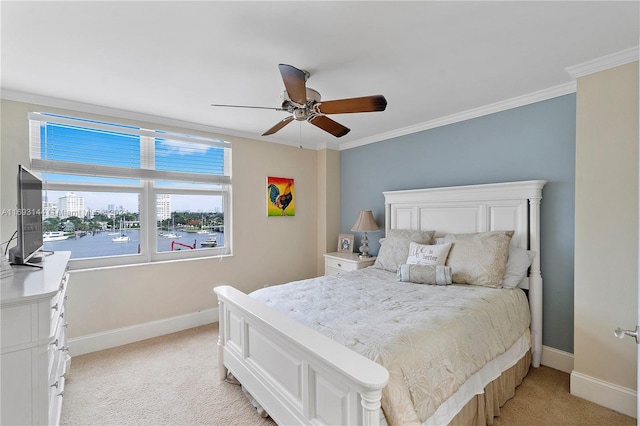 bedroom with light colored carpet, ceiling fan, and crown molding