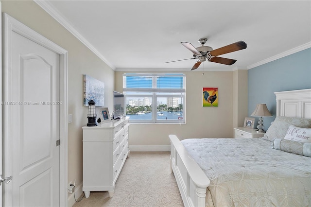 carpeted bedroom featuring ceiling fan and ornamental molding