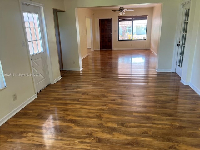 empty room featuring ceiling fan and dark hardwood / wood-style flooring