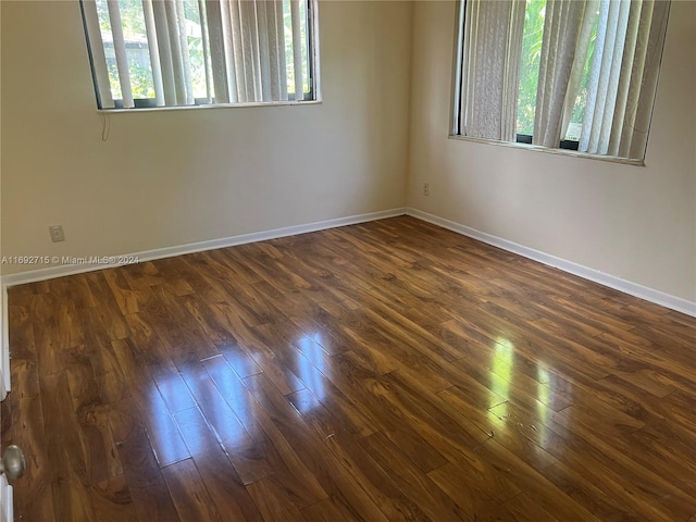 unfurnished room featuring dark wood-type flooring