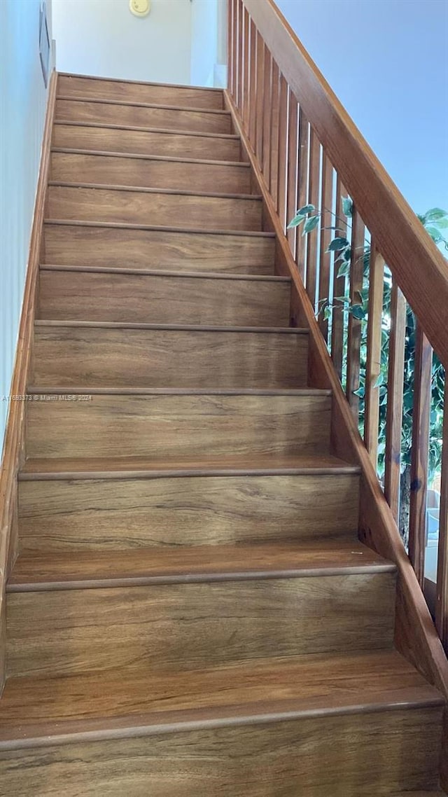 staircase with wood-type flooring