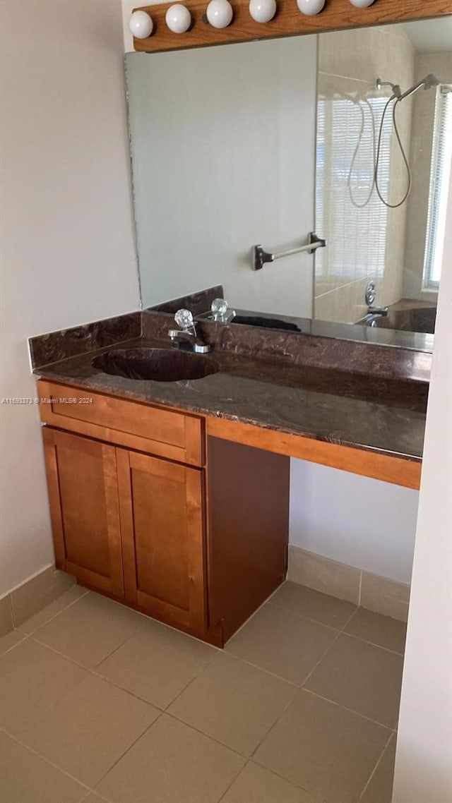 bathroom featuring tile patterned flooring and vanity