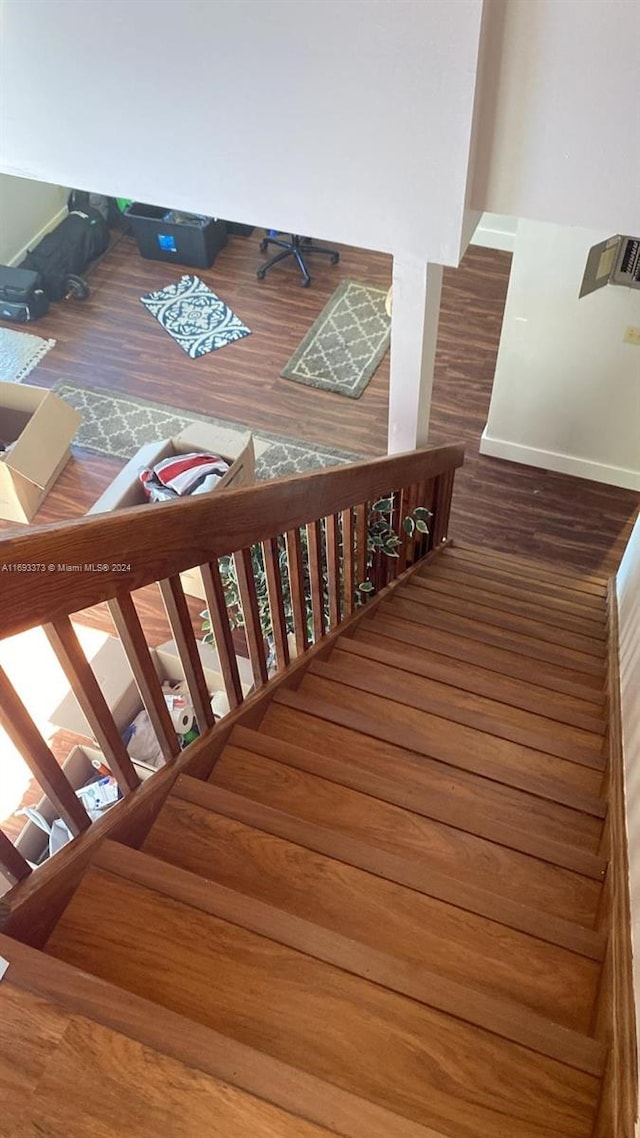 staircase featuring hardwood / wood-style floors