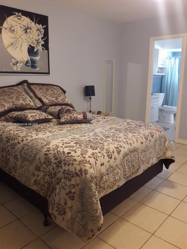 bedroom featuring tile patterned flooring and ensuite bathroom