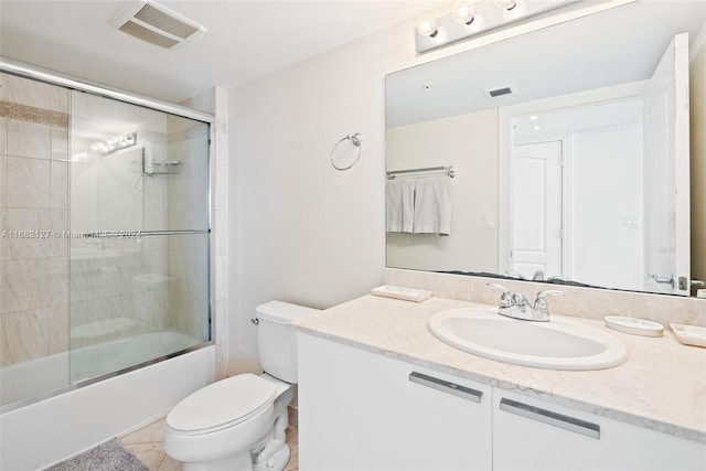 full bathroom featuring toilet, combined bath / shower with glass door, vanity, and tile patterned floors