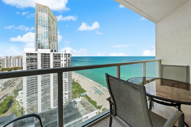 balcony with a view of the beach and a water view