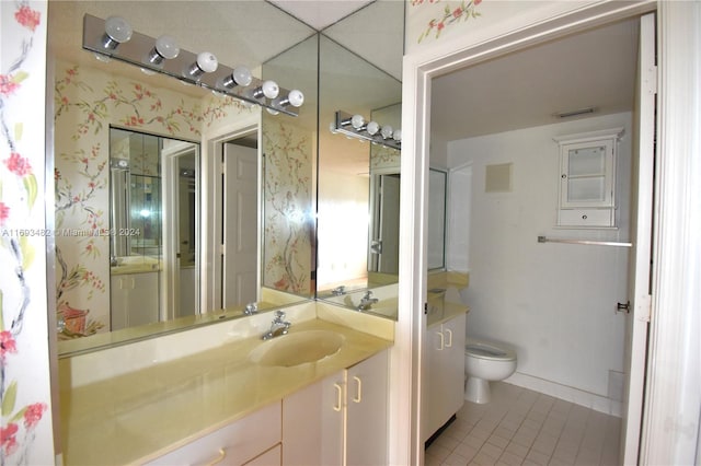 bathroom featuring tile patterned flooring, vanity, and toilet