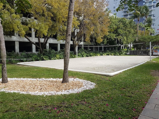 view of community featuring a lawn and volleyball court