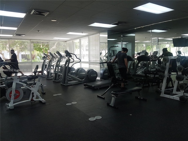 gym with a paneled ceiling