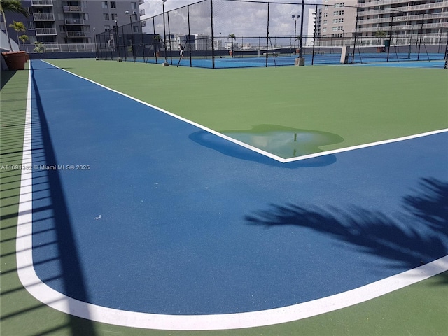 view of property's community featuring tennis court