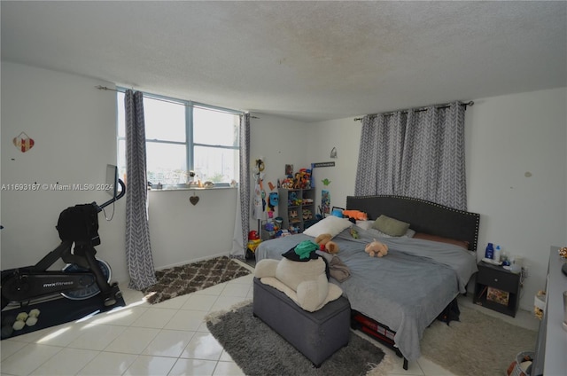 tiled bedroom featuring a textured ceiling