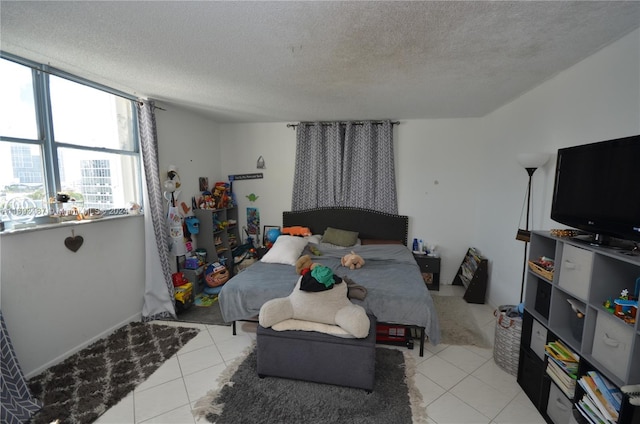 tiled bedroom featuring a textured ceiling