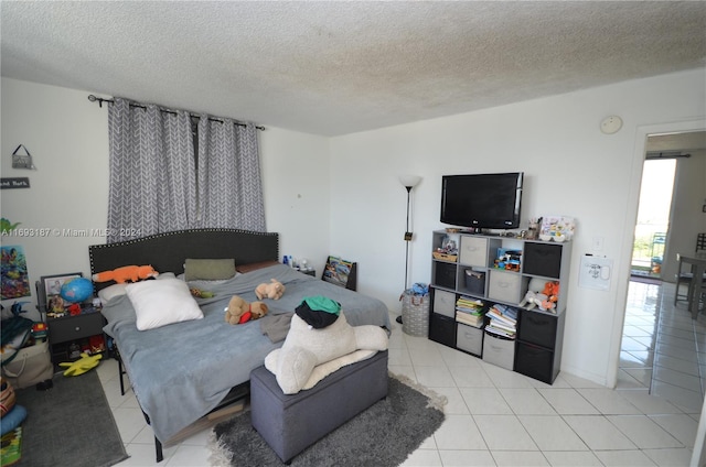 bedroom with a textured ceiling and light tile patterned flooring