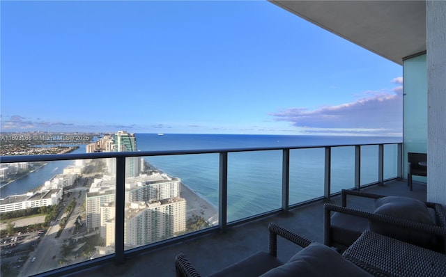 balcony featuring a water view and a city view