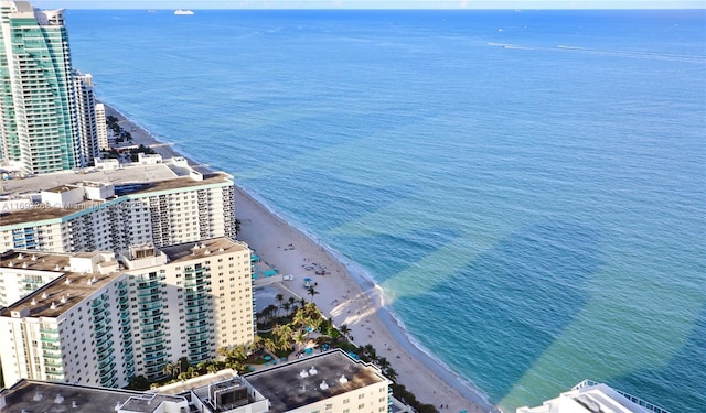 aerial view featuring a water view, a view of the beach, and a city view