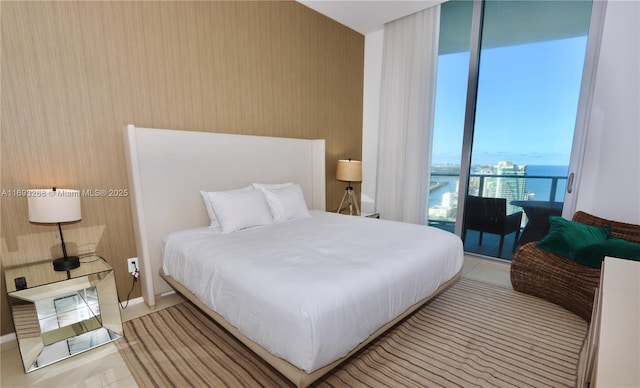 bedroom with a water view and light tile patterned flooring