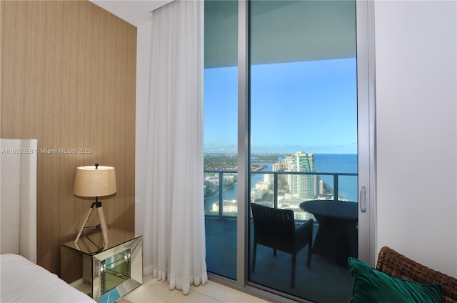 bedroom featuring a water view and light tile patterned flooring